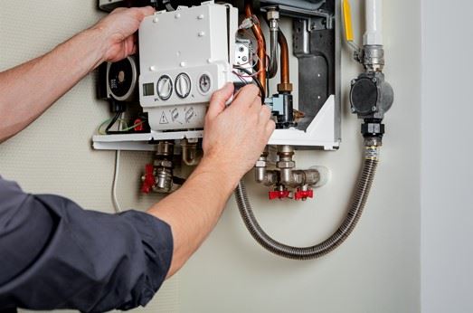 man repairing gas boiler